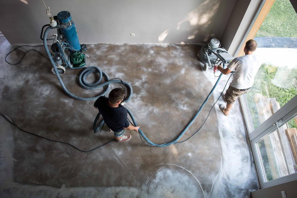 a couple of men standing on top of a cement floor